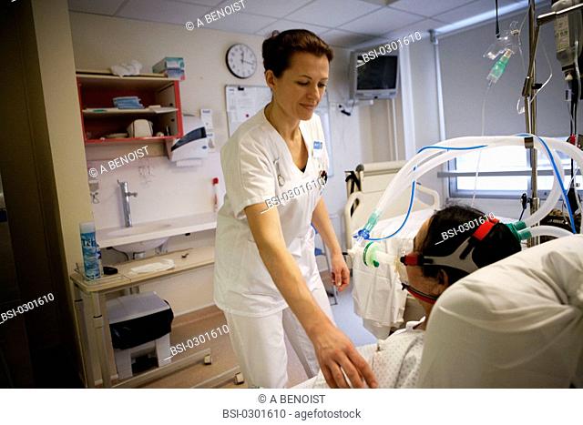 Photo essay from La Croix Saint-Simon Hospital, Paris, France. Department of resuscitation. Physical therapist and patient under artificial ventilation