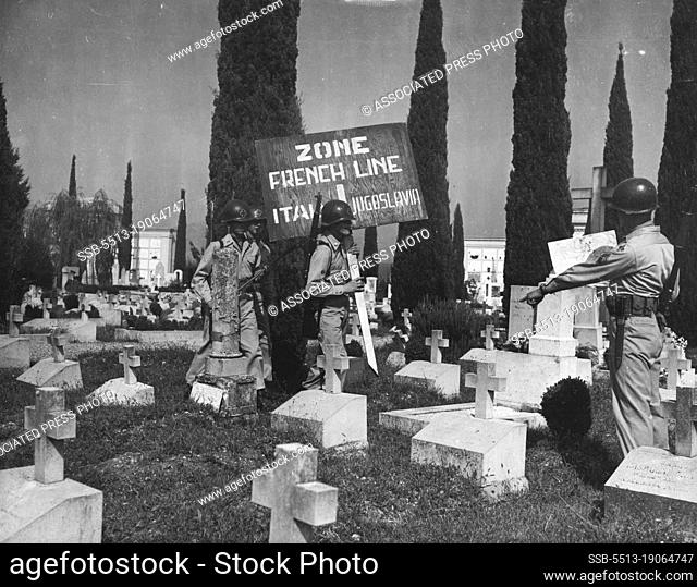 Marking New Italic-Yugoslav Boundary -- Soldiers place a marker in a cemetery on the outskirts of Gorizia, divided by the French Line, September 10