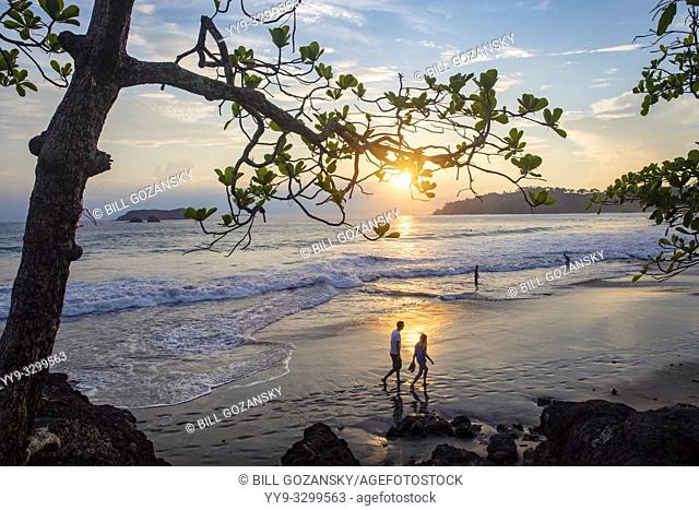 Couple walking in the sunset on Espadilla Norte Beach, Manuel Antonio, Quepos, Costa Rica