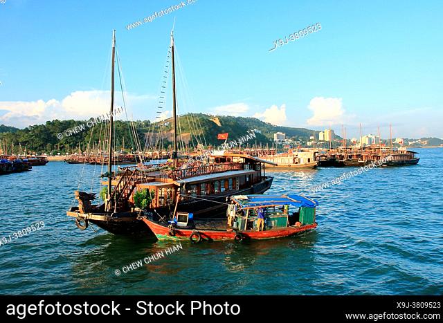 Traditional Vietnamese Sailing Junk Set against Limestone Karst Mountains Ha Long Bay Vietnam