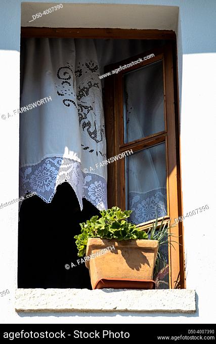 Gjirokaster, Albania July 20, 2022 An old window and a potted plant