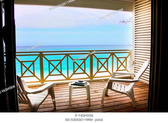 Empty chairs on wooden deck