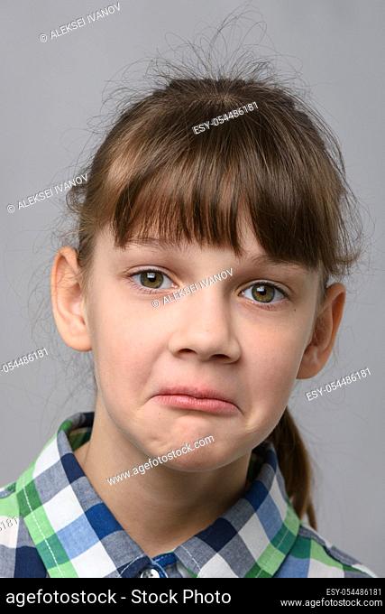 Portrait of a surprised ten year old girl, European appearance, close-up