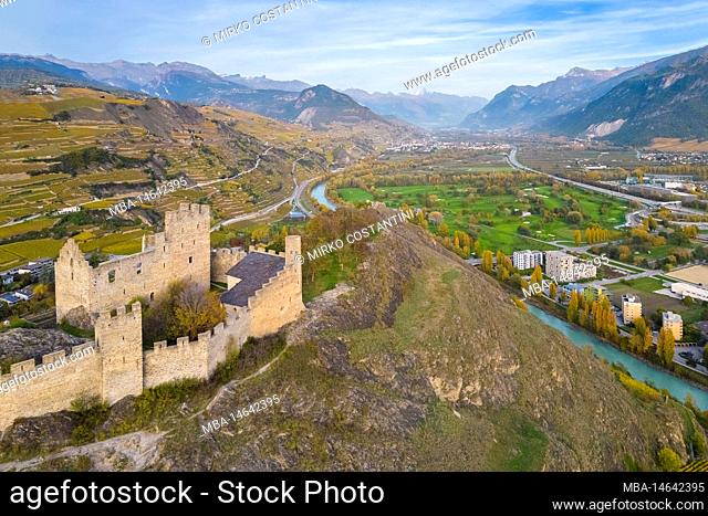 Aerial view of the Chateau de Tourbillon dominating the city of Sion and the surrounding vineyards in autumn. Canton of Valais, valley of the Rhône, Switzerland