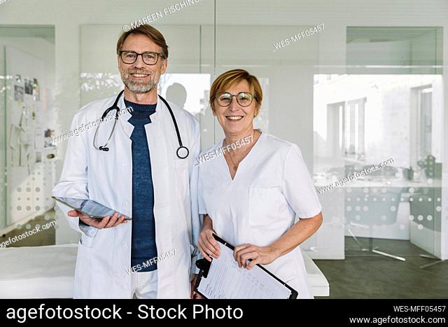 Portrait of confident doctor and assistant in medical practice