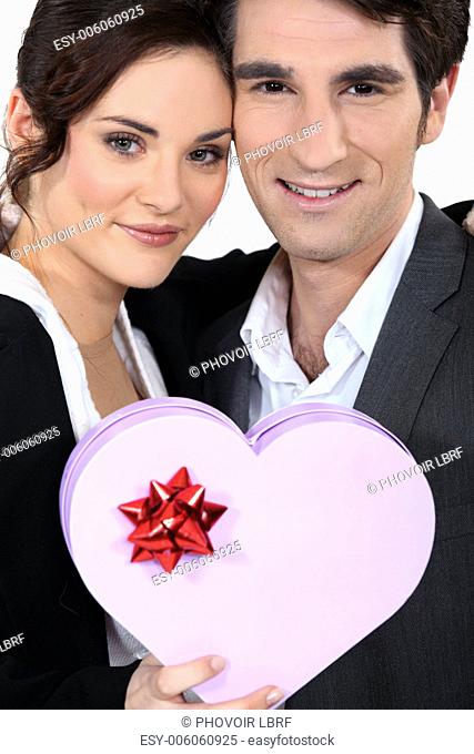 Romantic couple with heart-shaped box