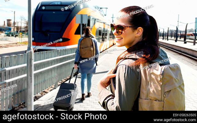 woman with backpack traveling by train in estonia