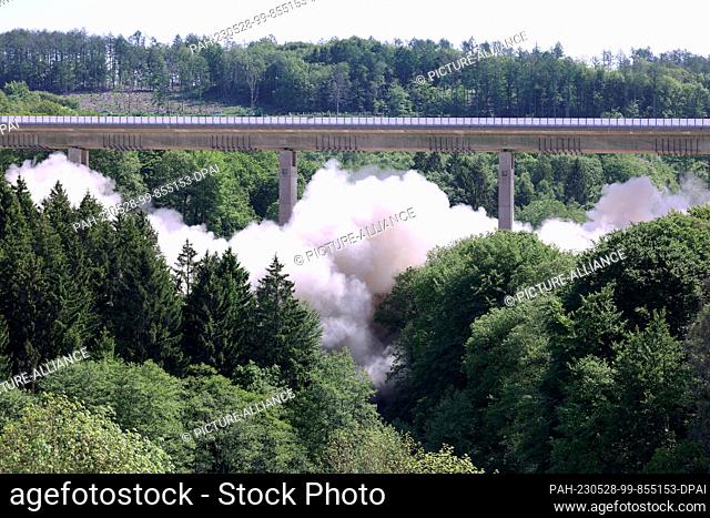 28 May 2023, North Rhine-Westphalia, Hagen: A large cloud of dust rises during the blasting of the first section of the Sterbecke valley bridge on highway 45