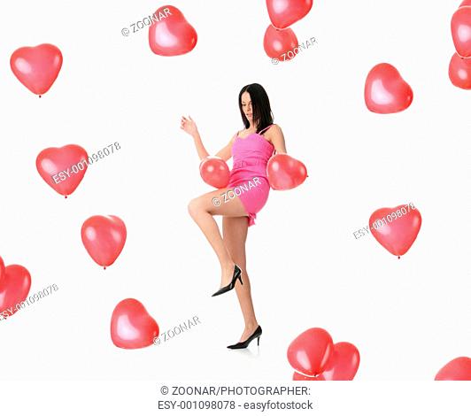 Beautiful young woman with red heart balloon