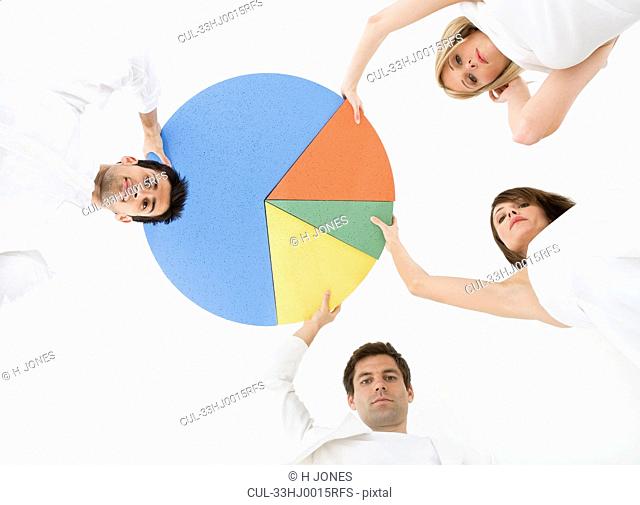 People holding pie chart