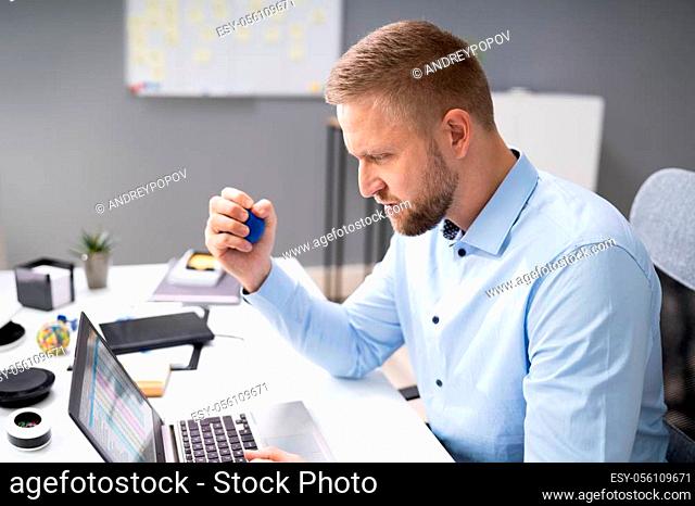 Close-up Of Businessman Holding Stress Ball In Hand