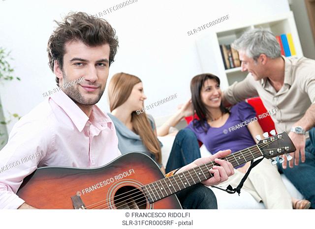 Smiling man with guitar and happy friend