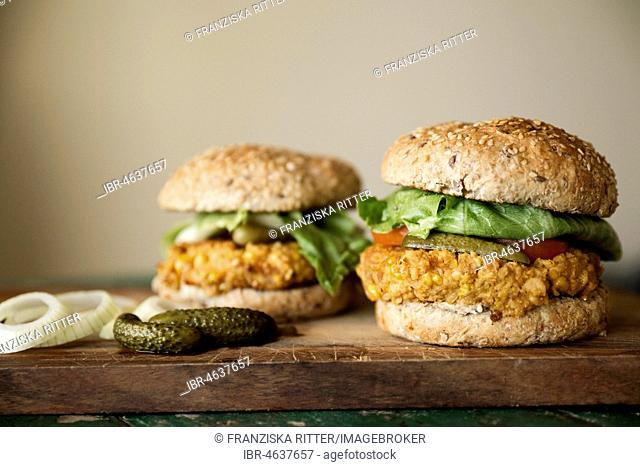 Vegan burgers with corn pattie, pickles and onions, food still-life, studio shot
