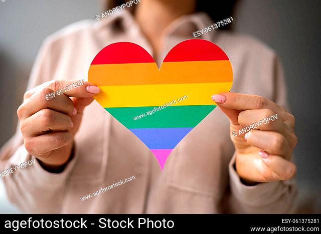 Close-up Of A Woman's Hand Holding Rainbow LGBT Heart