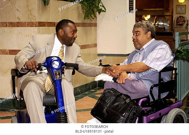 Two men talking during a break at a Disability Activist Conference