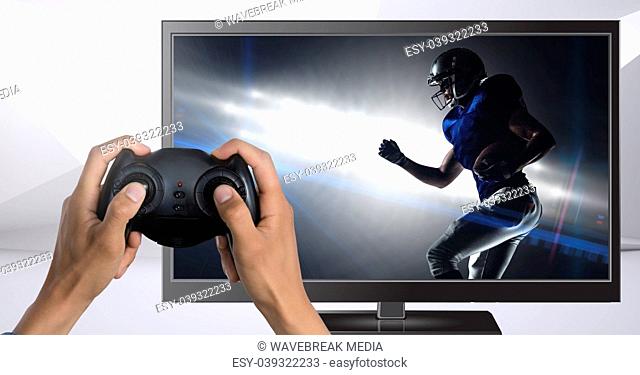 Hands holding gaming controller with american football player on television