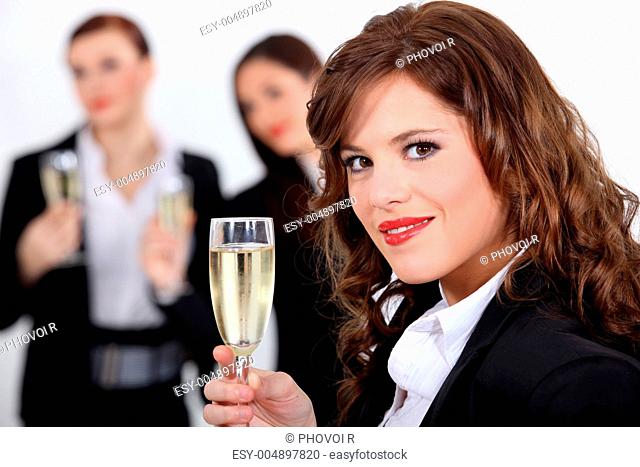 three businesswomen drinking champagne