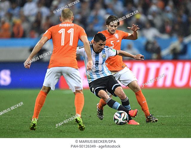 Enzo Perez (C) of Argentina and Arjen Robben (L) and Daley Blind (R) of the Netherlands vie for the ball during the FIFA World Cup 2014 semi-final soccer match...