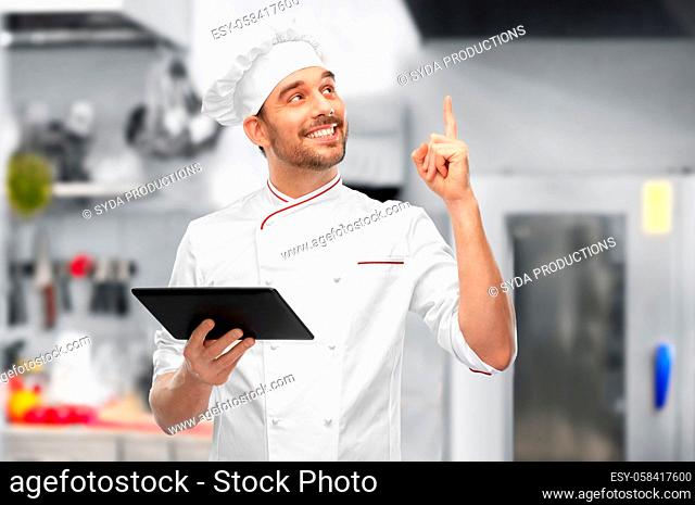 male chef with tablet computer pointing finger up