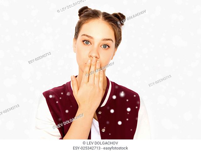 winter, christmas, people, expression and teens concept - confused teenage girl covering her mouth by hand over gray background and snow