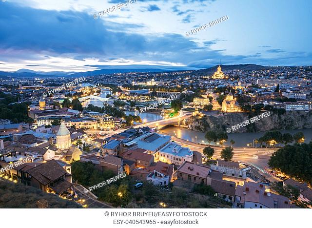 Scenic Top View Of Summer Evening Cityscape Of Tbilisi, Georgia In Illumination Lights With All Famous Landmarks, Sightseeings