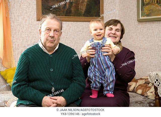 Happy Caucasian Senior Grandparents Holding Kid Baby