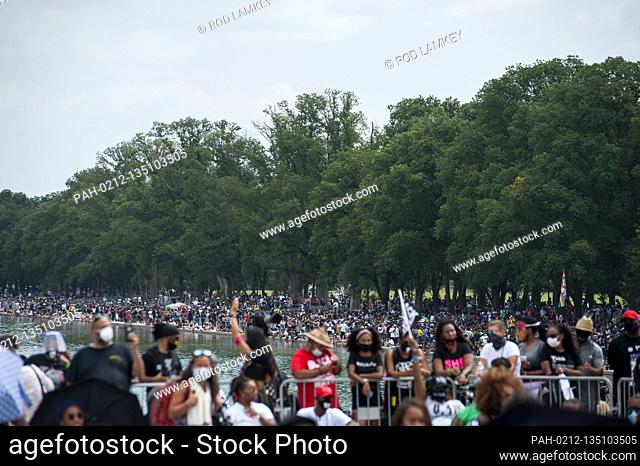 People fill the area of the Reflecting Pool during the “Get Your Knee Off Our Necks” March on Washington at the Lincoln Memorial in Washington, DC