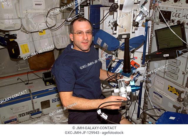 Astronaut Donald R. Pettit, Expedition Six NASA ISS science officer, works to set up Pulmonary Function in Flight (PuFF) hardware in preparation for a Human...