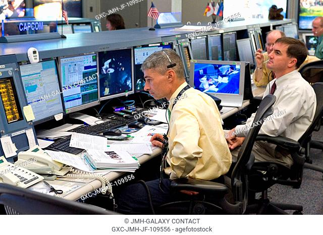 Mark Vande Hei (left) and astronaut Rex Walheim, both ISS Orbit 2 spacecraft communicators (CAPCOM), monitor data at their consoles in the space station flight...