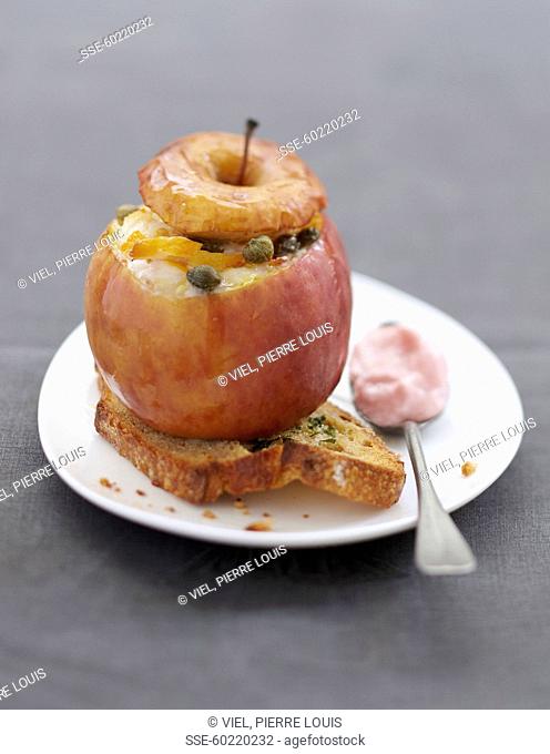 Oven-baked apple with stuffed with haddock and capers