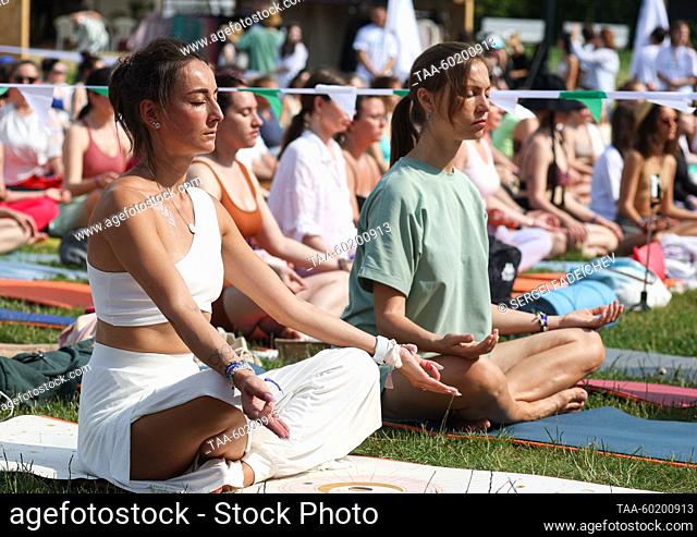 RUSSIA, MOSCOW - JULY 2, 2023: People meditate during Yoga Day Russia 2023, a yoga festival marking the International Day of Yoga, in Tsaritsyno Park