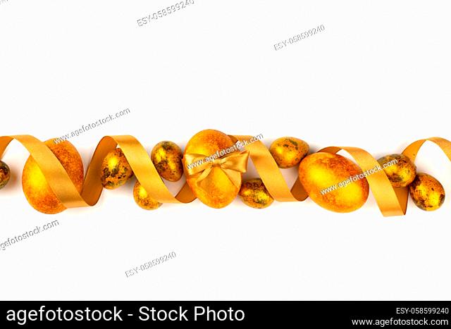 Easter egg composition with golden ribbon isolated on white background stripe line design element