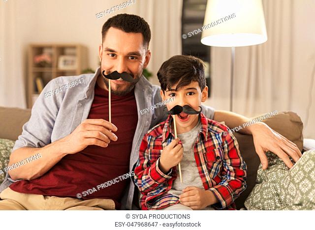 father and son with mustaches having fun