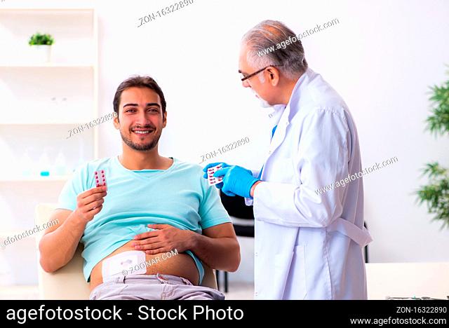 Injured man visiting experienced male doctor