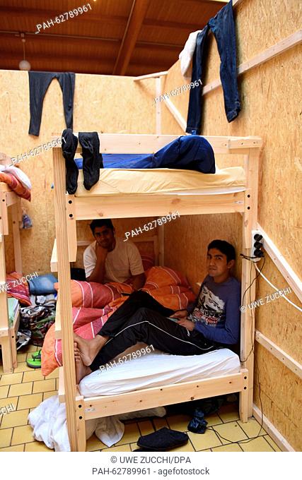 Pakistani refugees sit on a bunk bed in the refugee initial reception center in Lohfelden, Germany, 21 October 2015. The center has been in service in a former...