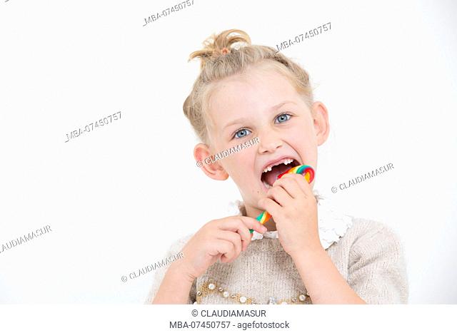 Girl eats candy cane, portrait