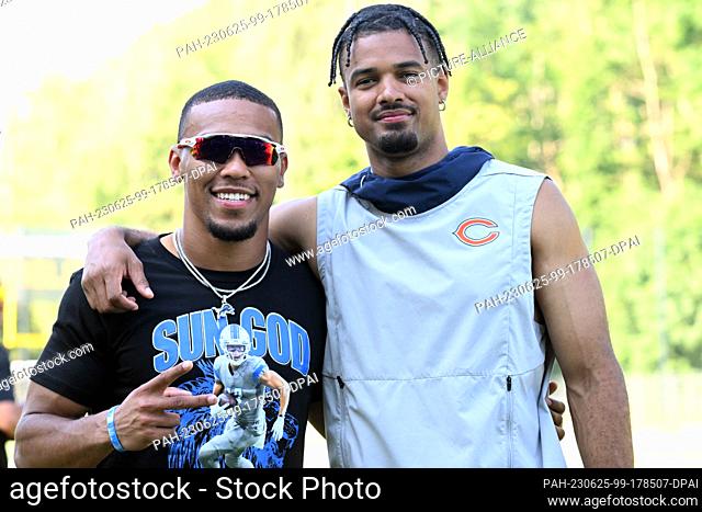 25 June 2023, North Rhine-Westphalia, Cologne: American Football: St. Brown Youth Football Camp. Equanimeous St. Brown (r) of the Chicago Bears and Osiris St