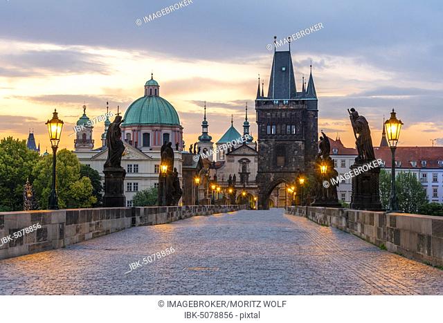Karluv most, Charles Bridge at dawn, dome of the Church of the Holy Cross, Charles Bridge with Old Town Bridge Tower, Prague, Bohemia, Czech Republic, Europe