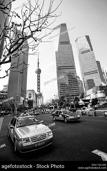 Shanghai, China - April 8, 2014: Taxi car in the street in Shanghai city. Black and white urban photography, wide angle shot