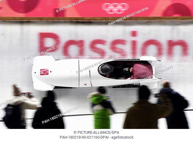 18 February 2018, South Korea, Pyeongchang: Olympics, Bobsleigh, Two Man Heat, Men, First Run, Alpensia Sliding Centre: Pilot Alexey Stulnev and pusher from the...