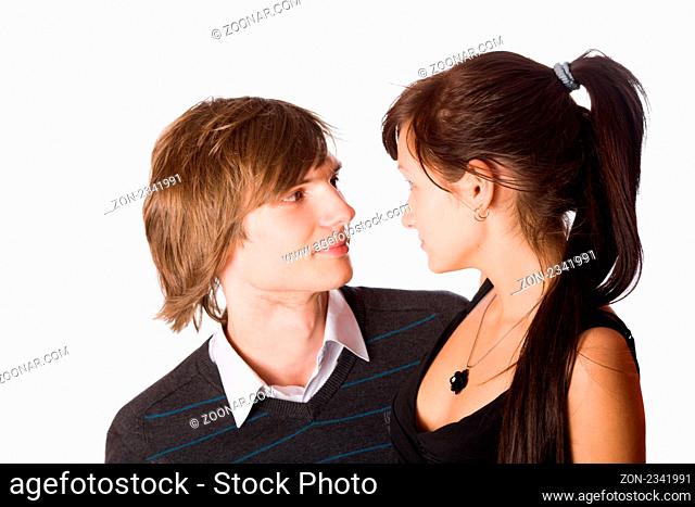 Young beautiful teenage couple sharing a secret isolated