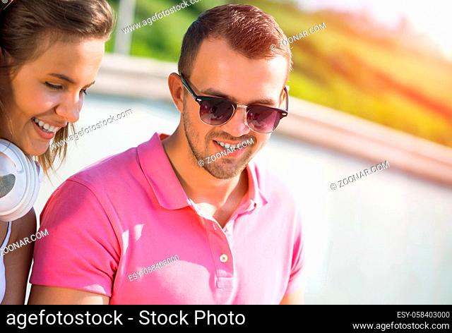 Young happy smiling couple having date outdoors