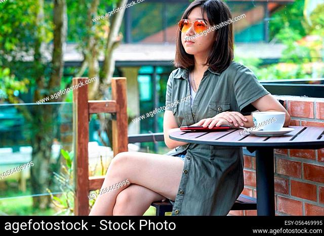 Pretty woman sitting in a cafe terrace with coffee cup