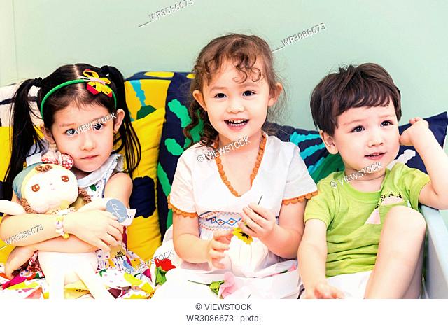 Happy children playing on the bed
