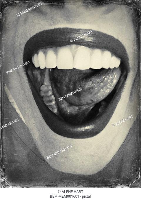 Close up of woman licking her teeth