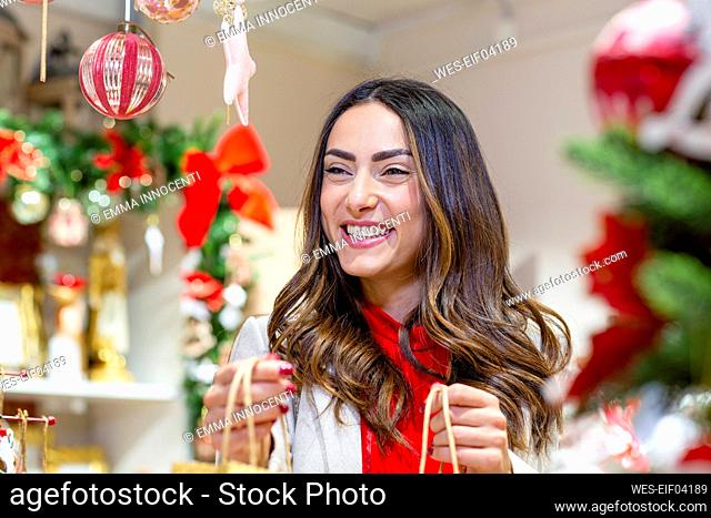 Happy beautiful woman in Christmas shop