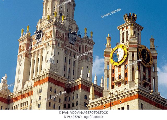 Stalin-era building of Moscow state university with clock and statues, Moscow, Russia