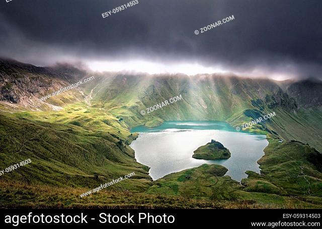 sunrays through clouds over alpine lake, Schrecksee, Germany