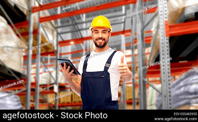 loader with tablet pc shows thumbs up at warehouse