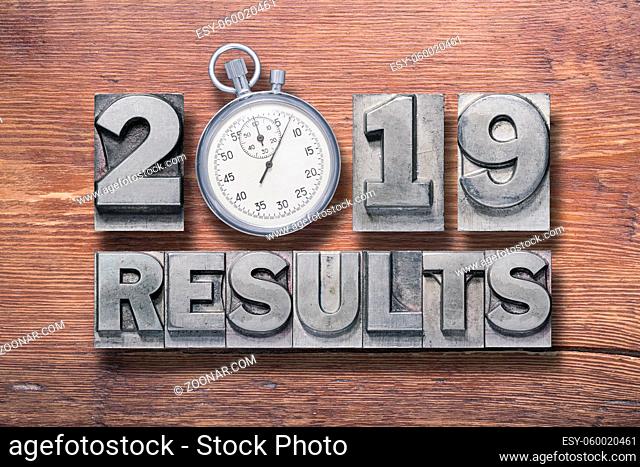 2019 results phrase combined on vintage varnished wooden surface with stopwatch inside